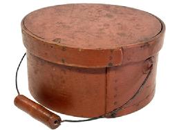 M1120 19th century New England bail handle Pantry Box in the original red paint with wire bail-handle with turned wood grip. The overlapping steamed and bentwood sides are secured by small tacks. Natural patina interior. Measurements: 9 5/8 top diameter x 9 ¼ bottom diameter x 4 ¾ tall.