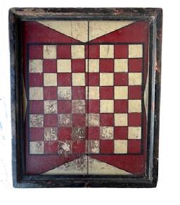 M102 Outstanding 19th century original painted checkers game board shows an outstanding original painted wood surface with applied molding surrounding the edges. The playing field is painted in red and white with black outlining on a red background, with white painted triangular designs outlined in black adorning all four sides of the playing field. Shaped applied molding secured with square head nails surrounds the entire board and retains remnants of several layers of paint, including bittersweet red and gold gild. Measurements: 18 wide x 1 ¼ thick x 22 ¼ tall.