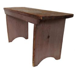 19th century Bench found in Chester County, Pennsylvania in early taupe paint. The top has rounded ends and an applied apron across the front. The legs are double mortised through the top with a nice half circle cut out on bottom of each leg. Bench is very sturdy as it is also reinforced with early handmade cut nails. Measurements are: 36” wide x 11 1/2” deep x 17” tall.