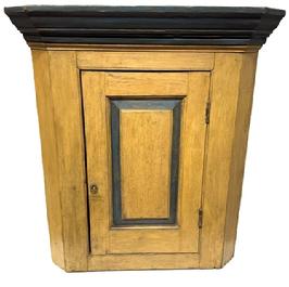 **SOLD** M195 Early 19th century Pennsylvania hanging Corner Cupboard in the original mustard and blue paint. This Cupboard has a single raised panel door which is mortised and pegged that opens to reveal a clean interior bearing a brown painted surface. Nice, applied molding along the top. Combination of pegged and square head nail construction. Circa 1820s. Measurements: 34 ½ tall and takes a 22 corner.