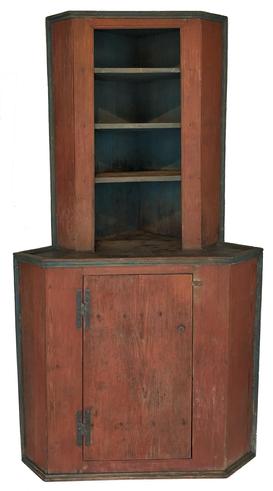 P139 Important Southern 18th century open top stepback corner cupboard, from Cumberland County North Carolina, one piece southern heart pine, rose head nail construction, This cupboard retains it original dry red painted case, with blue picture frame molding and blue interior. Single plank door with baton held in place with rose head nails, with blacksmith made H hinges. The opening of the cupboard is canted, with four shelves as well as a canted door, at the bottom ( wider at the bottom and nearer at the top). This rare cupboard was found in the 1980’s out of a private estate in the town of Fayetteville N.C. not many pieces of Furniture this early survive the Civil War, this is a rare form and style one of a kind. First time on the market Circa 1750 Measurements 82” tall x 32” at the waist molding x 23” at the top