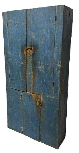 M262 19th century Mid-Atlantic flat wall cupboard bearing early blue painted surface. Unusual layout with two doors over one door configuration. The wood is yellow pine with square head nailed construction. Remnants of beaded edges by the door openings. Clean, natural patina interior - with inside of top featuring three fixed shelves, and interior of bottom featuring two fixed shelves. Measurements: 37 wide x 13 ¼ deep x 74 ¾ tall.