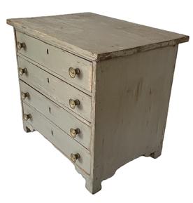 L41 Mid 19th century Pennsylvania Child's Chest of Drawers retaining gray painted surface. Chest features four dovetailed drawers resting on decorative cut out base. The wood is pine. Square head nail construction. Measurements: 18 5/8 wide x 13 ½ deep x16 ½ tall.   