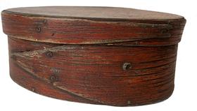 F38 mid-19th century. Bentwood construction having tacked lap joints. Oval pantry box in the original dry red paint with finger laps.