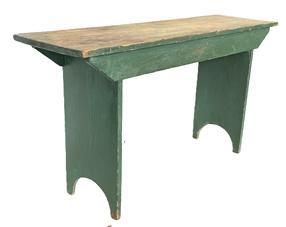 RM1556 Pennsylvania tall, sturdy pine bench bearing old green over the original green painted surface with scrubbed top. Double drop aprons are mortised into the legs which end in half-moon cut out feet. Early wire nail construction. Measurements: 48" long x 13 3/4" wide x 25" tall.