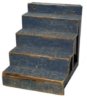 M155 Early 19th century Pennsylvania Country Store display shelf / steps bearing original dry, dark blue painted surface. Pine with small wire nail construction. Overall measurements: 20 wide x 23 ¾ deep x 22 ½ tall. The shelves/steps are 5 deep x 4 ½ tall. The top shelf/step is 5 deep x 3 tall.