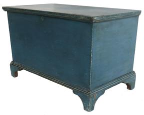 E206 EARLY 19TH CENTURY BLUE PAINTED PINE PENNSLYVANIA BLANKET CHEST, This is a wonderful early 19th Century painted blanket chest from South eastern Pennsylvania, with ORIGINA blue paint. The surface undisturbed, the exterior of the case crafted of six broad planks of Eastern White Pine, the sides and bottom joined with exposed dovetail construction. The base is affixed with small nails and the feet are delicate little brackets with molding around the top is affixed with pegs set at regular intervals, the lid lifting on original wrought iron strap hinges dovetailing to the front and sides.measurements: 37 1/2" W x 213/4" D x 23 3/4" H