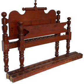 F186 19th century rope bed with red paint, the bed is in wonderful untouched condition and was greatly cared for by the family. This is an early 19th century bed it has generously formed turned columns with dramatic tight ringlet turnings with ball formed tops. The head board has two inset panels with a very unusual rolling pin top It has it’s original The bed measures 55” wide x 80” long x 52 1/2” tall. The interior between the rails measures 47” wide x 72” long