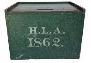 L507 19th century Pennsylvania slide lid Box in its original dry-green painted surface with the initials H. L. A. and the date 1862 painted in white on the front. A carved finger notch in the front edge of the lid allows easy opening of the smoothly sliding lid which opens to reveal a clean, natural patina interior. The wood is pine with square head nail construction. Measurements: 16 wide x 11 ½ deep x 11 ¾ tall.