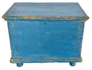**SOLD** M139 18th century Eastern Shore, Maryland Miniature Blanket Chest retaining blue painted surface. Six-board yellow pine with dovetailed case and applied moldings to top and bottom, resting on turned feet. Prominent wooden peg construction throughout, with a few T and rosehead nails visible. Natural patina interior. Circa 1780-1800. Measurements: 16 ¼ wide x 11 ¼ deep x 12 ½ tall.