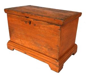 F173 Striking 18th century diminutive Chest, in the original pumpkin paint. It has an applied bracket base on all four sides, very unique hand made butterfly hinges, held in place with rose head nails. One board white pine tee head nail construction. Measurements are 10" wide x 6 1/2" deep x 6 3/4" tall