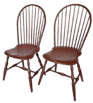 L12 Pair of early 19th century New England nine spindle bow back Windsor Chairs featuring beautiful saddle seats, bamboo turned spindles and legs with a center stretcher fastened to side runners with bold turnings in old red over original black paint. Circa 18001820. From a collection in Pennsylvania. Measurements: 20 ½ wide across front legs x 38 ½ tall (back). Seats are 17 wide x 17 deep x 17 ¼ tall.