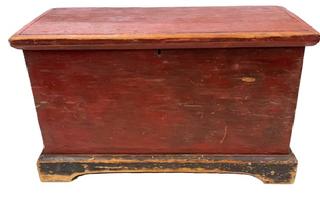 **SOLD** M26 Late 18th century Maryland blanket chest bearing original red paint with applied bracket base bearing original black painted surface and cut out feet. The initials J.C are painted inside the lid. Pine, six board construction with a combination of T nails and rosehead nails and applied, hand planed molding around the lid. Clean, natural patina interior. Circa 1790s-1800. Measurements 31 ½ wide x 15 deep x 18 tall.