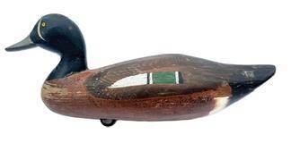L205 Vintage Upper Bay Blue Winged Teal Drake Duck Decoy carved by Paul Gibson (1902-1984) of Havre de Grace, MD. This decoy bears its original painted surface, and the original weight, staple and ring all remain intact on the bottom. Paul Gibson was an avid hunter and a fireman on the Edgewood Arsenal (now known as Aberdeen Proving Ground South), retiring in 1965 as the Department Chief. In 1915, Gibson began using his spare time to make decoys � of which have become highly sought after for their quality. 