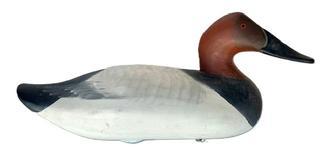 L411 Canvasback Drake decoy carved by Madison Mitchell (1901-1993) from Havre de Grace, Maryland. Electric pencil signature on bottom - "R. Madison Mitchell � Havre de Grace, Md - 1975� Decoy has a slightly turned head, retains its original weight, staple and ring on bottom and bears its original painted surface with dry surface - never oiled or waxed. 