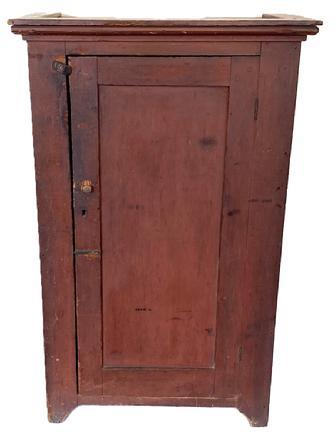 **SOLD** K137 Wonderful early 19th century Pennsylvania one door cupboard in original red painted surface featuring cut out feet, applied molding around the top and a panel door that is fully mortised and pegged. Clean interior with sturdy shelves for storage. Square head nail construction. Circa 1810s-1820s. Measurements: 30 &frac14;� wide x 16� deep x 48 &frac12;� tall (Case measures 27 &frac14;� wide x 14 12� deep).    