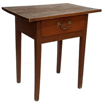 F604 (F485) 19th century one-drawer table or stand in original red painted surface having a dovetailed drawer with brass pull, pegged on top, which is one board, and four-square tapered legs. The wood is birch throughout. New England, circa 1800. Measurements: 24" wide x 16 1/4" deep x 25" tall
