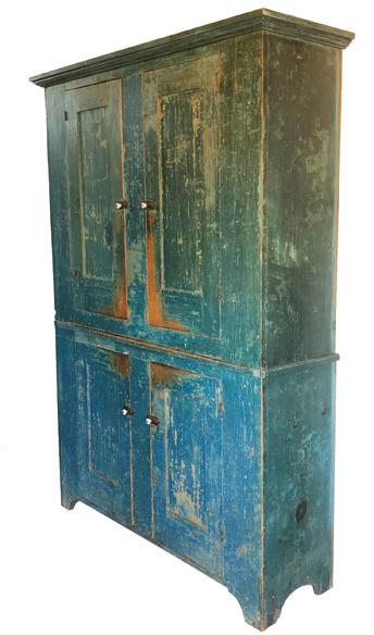 F13 A fine and unusual 19th century York County Pennsylvania flat wall storage cupboard retaining it's original blue paint, Four mortise and tenon joined and pegged paneled doors, opening to a shelved light mustard-painted interior, high shaped cut-out feet with an applied molded top. Circa 1820-1840 Measurements: 59" wide x 81 3/4" tall x 16" deep