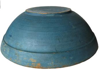 F64 Wonderful New England wooden bowl, ca. late 18th to early 19th century. Bold form, with broad inner rim tapering subtly downward, showing strong evidence of slow lathe turning, and resting on raised foot. Dry robin egg blue paint is the first coat and the original coat, with diameter 19” ( out of Round) while standing about 7” deep rather than the more typical shallower 5 inches. The bowl has an early crack that was repaired 100 years ago with a metal patch. The painted surface has typical minor abrasions, from years of use. This is by far one of the best form and blue painted bowls I have ever seen.