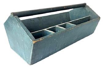 E121 Late 19th century Tool Carrier/ Carpenter's Tote bearing wonderful original dry, weathered blue paint. This carrier features nice, high angle-shaped ends with canted sides and a deep well outfitted with a stationary tray with sections for various nails/tacks, etc. The wood is pine with wire nail construction. This is a true country classic with beautiful blue paint. Measurements: 26 ¾ long x 14 ¼ wide x 10 ½ tall at handle. The sides are 6 ¼ tall.