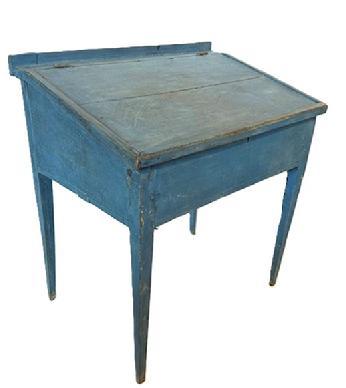 L483 Early 19th century Pennsylvania painted pine School Master's Desk with original dry blue paint and the initials B.M. prominently painted on the back. Desk rests on gracefully tapered hepplewhite legs that are mortised and pegged to the apron. Applied molding secured with sturdy square head nails surrounds the slanted lift lid that opens to reveal a clean, natural patina interior. Measurements: 31 ¼ wide x 21 ¾ deep x 34 tall (back) x 29 ½ tall (front). Clearance from apron to floor is 21 ¼.