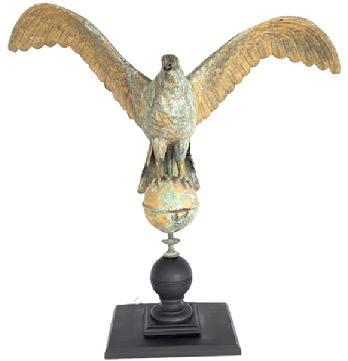 **SOLD** J40 Majestic large sized 19th century hollow-bodied copper Eagle weathervane. This depiction of an eagle with outstretched wings perched atop a ball shows excellent hand-hammered details throughout. Wonderful, weathered patina with remnants of original gold gild surface with areas of verdigris. Nicely mounted on a wooden base for display purposes. Measurements: ~37 &frac12;� wingspan. Mounted height is ~33� tall