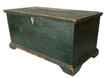 F164 New England Green painted miniature blanket chest with inlaid ivory lock escutcheon, dovetailed case and applied dovetailed bracket base that circumvents the entire chest. This chest has very fine dovetailed joints - with dovetails every 1/2" which is very rare. The interior retains its original light cream paint and has a small glove box with original brass hinges and a single dovetailed drawer beneath the glove box. Circa 1820's. Measurements: 21" wide x 10 1/2" deep x 10" tall