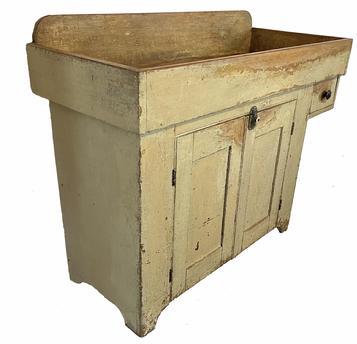 **SOLD** H1072 York County, Pennsylvania drysink with overhanging dovetailed drawer and mortised stretcher bearing light mustard over original yellow painted surface. Beaded edge around doors. Natural patina interior. Circa 1850s.