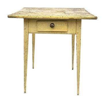 M149 Lancaster County, Pennsylvania Hepplewhite splay leg one drawer table with original mustard yellow painted surface resting on tall, very gracefully tapered splay legs. Mortised and wooden pegged construction with deeply carved beaded edge along the bottom edge of the apron on all sides. The drawer is square head nail construction with original brass knob. The wood is pine. Circa 1820s. One-board top. Measurements: 25 wide x 22 ½ deep x 27 ¾ tall.