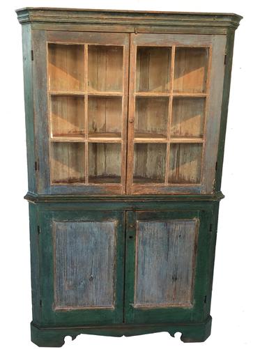 F14 Late 18th century Eastern Shore Maryland twelve window lites, Corner Cupboard, in the original blue and green paint. The doors are full mortised and double pined. The Cupboard is resting on an applied base with a beautiful high waisted center molding and nice top cornice molding all rose head and tee nails construction circa 1780 Measurements are 35" corner and it stands 79 1/2' tall
