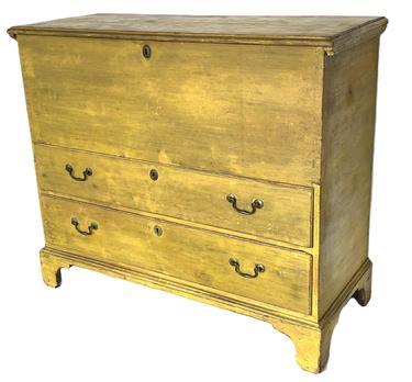 K317 Late 18th century New England chest over two drawers boasting vibrant yellow painted surface . The case and drawers are dovetailed. Tall, applied bracket base is secured with early �T� nails. Original strap hinges 