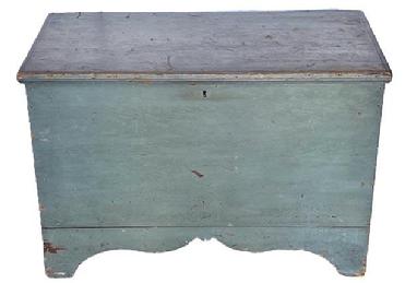 **SOLD** L109 Mid-19th century New England original blue painted tall footed pine blanket chest featuring six-board, square head nailed construction with applied edge molding around the hinged lid all flanked by solid ends boasting a high, unusual cut-out "whale's tail" profile to the ends of the base and a decorative cutout along the front of the base. Clean, natural surface interior. Circa 1850s. Measurements: 37 ¾ wide x 19 ¼ deep x 25 ¾ tall.