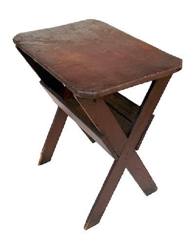 L264 Small sized, very early 19th century New England Sawbuck Table bearing a one-board pine top with clipped corners resting on crossed base with deep apple tray below. Original Spanish Red painted surface with a Museum mark visible on the edge of tables top. Primarily square head nail construction with one rosehead nail also found. Circa 1820. Measurements are 26 ¾ wide x 18" deep x 29" tall.