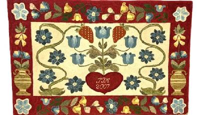 M1125 Exceptional identified, dated and award winning Mid-Atlantic hand-hooked rug with a central floral and heart motif surrounded by a 5 ½ wide border featuring tall urns of flowers on each end and vines and flowers along top and bottom. The initials JTK and date 2007 are hooked within the center of the heart. A First-Place Blue Ribbon dated 2009 from the Maryland State Fair Timonium is attached. Vibrant colors of wool strips are tightly hand hooked on Monks cloth. Mounted and ready to hang. Measurements: 48 wide x 31 tall. (JTK = Julie T. Kappler).