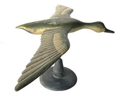 J230 Full sized Flying Duck Decoy with very detailed carved wings and nice dry, original painted surface. Carver unknown. Mounted on a wooden base for display purposes. Measurements: 31 ½ wingspan x 18 ½ beak to tail. The base is 8 ¾ diameter. Overall mounted height is 13 ½ tall.