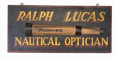 J321 Hand painted New England Trade Sign advertising “Ralph Lucas Nautical Optician” with applied wooden replica of a “No. 2” telescope. Measurements: 23 3/8” wide x 10 ¾” tall x 5/8” thick. (The applied wooden replica telescope measures 1 1/8” thick x 17 ¼” long x 3 1/8” tall.)