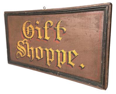 Z229 late 19th century Store front Sign " Gift Shoppe." two sided wonderful paint colors of brown background with gold, black and red letting. painted on board applied molding 23" long x 12" tall