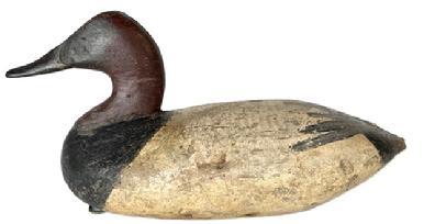 L222 Branded Upper Bay Canvasback Duck Decoy � attributed to Graham - branded "CA" and HBS" (for H.B Strong who hunted near Remington Farms) on bottom. Original weight, ring and staple remain intact on bottom. Early second coat of working painted surface with areas of original paint showing as well as evidence of being shot over. 