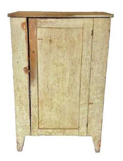 **SOLD** K1604 Early 19th century Lancaster County, Pennsylvania one door cupboard bearing original painted surface resting on tall cut out feet. A beaded edge runs along each side of the paneled door that opens to reveal shelves for storage and a clean, natural patina interior. Square head nail construction. The wood is pine. Circa 1820s. Measurements:  31 &frac14;� wide x 16 &frac34;� deep x 48 &frac34;� tall.     