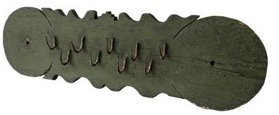 F156 18th century fancy wooden game rack in old green paint. Nine staggered and offset wrought iron hooks for hanging wild game or drying herbs. Hooks are held in place by being folded over on back. Mounting holes at both ends. Measurements: 35” wide x 9 ½” tall x 3” deep with hooks