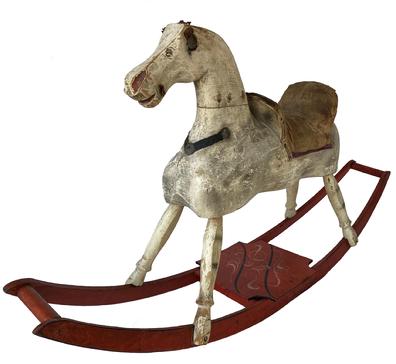 19th century hand made wooden Rocking Horse in it's original paint showing wonderful wear from lots of love, the rockers are painted red with a black and mustard decorated platform. Early in the 19th century, woodworkers, most from New England, started making more sculptural horses. "These were hand-made, "It was Dad in the woodshop cranking out the first ones. . While almost always made of wood, some were padded and others had leather or cloth saddles and reins, features that have often been lost to time.