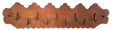 M110 19th century Wood and Wrought Iron Meat / Game Rack bearing original red washed surface, with nine delicate hand-forged wrought iron hooks clinched to a pine board boasting a decorative shaped edge along the top and a scalloped edge along the bottom. Square shaped hole on each end for hanging purposes. Circa 1850s. Measurements: 31 ¾ long x 8 ¼ tall x ¾ thick.
