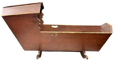 M326 Early 19th century Pennsylvania original red painted Hooded Cradle with canted, dovetailed case resting on shaped rockers. There is a decorative cutout handle on each side and shaped sides below the hood. The interior of the cradle is painted red also. The wood is pine, dovetailed with square head nail construction. Measurements: 50 ¾ long x 18 ½ wide (hood) x 15 ½ wide (case) x 24 tall (hood).
