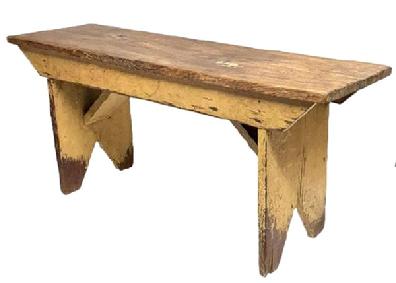 **SOLD** M246 Late 19th century Caroline County, Maryland original mustard painted bench with bootjack cut out feet and double drop aprons with shaped ends and original angled supports below the seat. The wood is yellow pine with wire nail construction. Very sturdy. Circa 1870s-1880s. Measurements: 37 ½ wide x 11 ¼ deep x 17 tall.