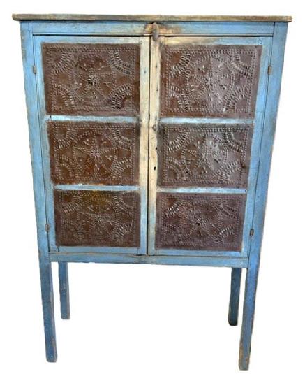 M1116 Early 19th century, Pennsylvania,( Circ 1820) original blue painted, 12 tin Pie Safe With the original hand punched tins in the star pattern, The Pie safe boasts beautiful pith sawed three board back, and rests on tall legs. It has a Clean, natural patina interior, with three fixed shelves. Measurements are 16" deep x 38 ¼ wide x 58 ¾ tall (the height from the floor to the case is 20 ½).