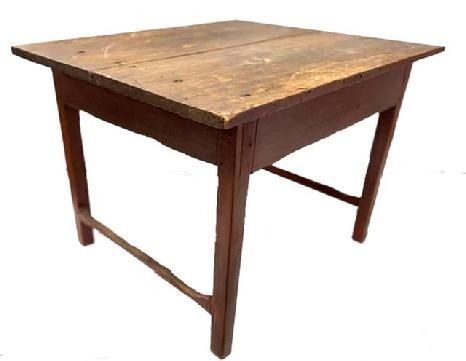 M247 Fantastic 18th century New England stretcher base tavern table in original old red painted surface with scrubbed top. The boards on the two-board top are a full 1 thick and are secured to the base with large rosehead nails. The apron, legs and stretchers are fully mortised and pegged. Stretchers are original and show great wear. Circa 1770. Measurementsn to floor).