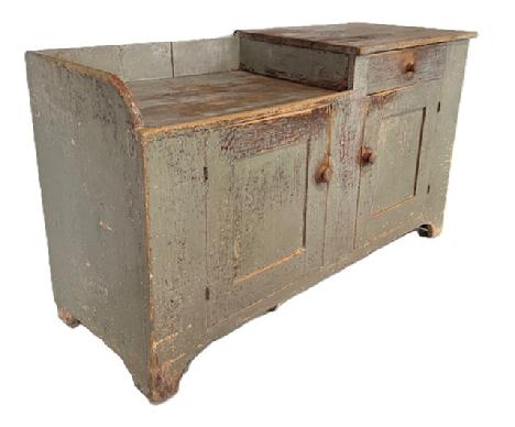 M54 Pennsylvania drysink bearing original gray painted surface with unusual form featuring a half-well with raised workspace and one dovetailed drawer over two mortised and pegged doors. The wood is pine with one-board construction with three-board back secured with square head nails. Circa 1820s-1840s. From Johnstown, Pennsylvania. Measurements: 57 ¼ wide x 22 deep x 32 ½ tall.