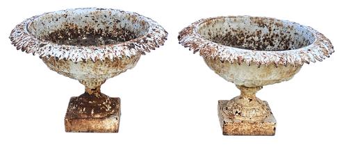 K179 Late 19th century  Matching pair of ornate Cast Iron Garden Urns retaining old white painted surfaces. Urns are solid cast iron with leaf patterned rims resting on square bases. Measurements:  21 across tops (openings are 15 ½ diameter) x 7 ¼ square bases x 13 ½ tall