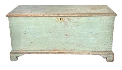 **SOLD** X33 Exceptional form 18th century Berks County, Pennsylvania Chippendale style Blanket Chest with the original dry blue paint featuring a dovetailed case with outstanding applied bracket base bearing beautiful cut out feet and a molded edge surrounding the top that is secured with wooden pegs. The brass Chippendale escutcheon is original to the chest. The interior bears clean, natural patina and boasts the original fish tail hinges and a lidded glove box. Circa 1770s. Measurements: 44 ½ wide x 20 deep x 21 tall.