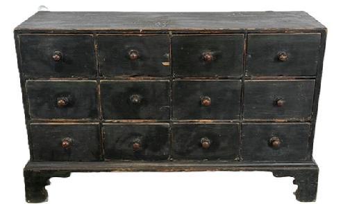 L406 19th century New England 12 drawer Apothecary in original Windsor green paint with dovetailed case and drawers, resting on an applied bracket base with decoratively cut out feet. The wood is pine with small wire nail and dovetail construction. Circa 1840s. Measurements: 34 ½ wide x 10 ½ deep (top) x 11 ½ deep (base) x 22 tall.